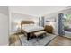 Comfortable bedroom with a wood bed frame, and blue and white patterned curtains at 107 Wimbledon Ct, Cary, NC 27511