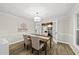 Elegant dining room with wood floors, stylish chandelier, and open access to the living area at 107 Wimbledon Ct, Cary, NC 27511