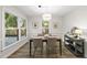 Bright dining room featuring wainscoting, backyard views and contemporary light fixture at 107 Wimbledon Ct, Cary, NC 27511