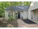Charming home entrance featuring a decorative door, brick walkway, and manicured landscaping creating curb appeal at 107 Wimbledon Ct, Cary, NC 27511