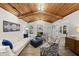 Well-lit living room featuring a wood ceiling, fireplace, and elegant decor at 107 Wimbledon Ct, Cary, NC 27511
