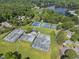 Overhead shot of neighborhood tennis courts, close to homes and a tranquil lake, with beautiful surrounding greenery at 107 Wimbledon Ct, Cary, NC 27511