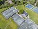 Aerial view of well-maintained tennis courts in a lush, green community setting, offering an active lifestyle at 107 Wimbledon Ct, Cary, NC 27511