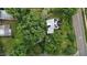 An aerial view showcases this leafy property with solar panels on the home's roof at 1090 S Fifth St, Mebane, NC 27302