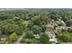 Aerial view of a home surrounded by lush greenery in a tranquil, wooded neighborhood at 1090 S Fifth St, Mebane, NC 27302