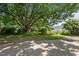 Large backyard with mature trees, garden beds, and fencing, providing a private outdoor space at 1090 S Fifth St, Mebane, NC 27302