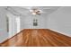 Bright bedroom featuring hardwood floors, a ceiling fan, and large window at 1090 S Fifth St, Mebane, NC 27302