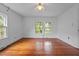 Bright bedroom featuring original hardwood flooring, two windows, ceiling fan and neutral walls at 1090 S Fifth St, Mebane, NC 27302