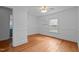 Bedroom with hardwood flooring, neutral paint, open shelving, and a view to another room at 1090 S Fifth St, Mebane, NC 27302