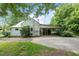 Home exterior with covered patio and carport, complemented by lush landscaping and a driveway at 1090 S Fifth St, Mebane, NC 27302