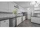 Galley kitchen featuring stainless steel appliances, white cabinets, and modern subway tile backsplash at 1090 S Fifth St, Mebane, NC 27302