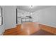 Bright living room with hardwood floors adjacent to the modern kitchen with white cabinets at 1090 S Fifth St, Mebane, NC 27302