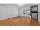 Living room with hardwood flooring, brick accent wall and laundry hook ups at 1090 S Fifth St, Mebane, NC 27302