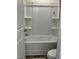 Clean bathroom featuring a bright white tub and shower combination with built-in shelving at 1116 Sidney Creek Dr # 1116, Zebulon, NC 27597