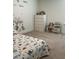 Cute bedroom featuring a playful dinosaur themed bedding and a decorative animal wall decal at 1116 Sidney Creek Dr # 1116, Zebulon, NC 27597