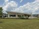 Modern clubhouse with an outdoor kitchen, dining area, and well-maintained landscaping at 1116 Sidney Creek Dr # 1116, Zebulon, NC 27597