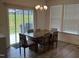 Bright dining room with sliding door access to outdoor space and contemporary chandelier lighting at 1116 Sidney Creek Dr # 1116, Zebulon, NC 27597