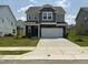 Charming two-story home with stone accents, a two-car garage, and well-manicured lawn at 1116 Sidney Creek Dr # 1116, Zebulon, NC 27597