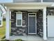 A covered entryway and stone accents welcomes you to the front door at 1116 Sidney Creek Dr # 1116, Zebulon, NC 27597