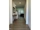 Bright hallway with beautiful wood flooring and access to living area and stairs at 1116 Sidney Creek Dr # 1116, Zebulon, NC 27597
