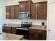 Updated kitchen features stainless appliances, modern countertops, and ample cabinet space at 1116 Sidney Creek Dr # 1116, Zebulon, NC 27597