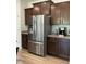 Modern kitchen featuring a stainless steel refrigerator and complimentary dark cabinetry at 1116 Sidney Creek Dr # 1116, Zebulon, NC 27597