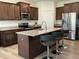 Modern kitchen featuring granite countertops, stainless steel appliances, and an island with bar seating at 1116 Sidney Creek Dr # 1116, Zebulon, NC 27597