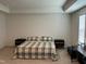 Spacious bedroom featuring neutral carpet, a plaid bedspread, and a tray ceiling at 1116 Sidney Creek Dr # 1116, Zebulon, NC 27597