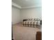 Spacious bedroom featuring neutral carpet, a plaid bedspread, and a tray ceiling at 1116 Sidney Creek Dr # 1116, Zebulon, NC 27597