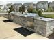 Outdoor community grilling area featuring stone detailing and professional stainless steel grills at 1116 Sidney Creek Dr # 1116, Zebulon, NC 27597