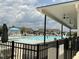 Community pool with a mushroom fountain, seating, and homes in the background at 1116 Sidney Creek Dr # 1116, Zebulon, NC 27597