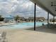 Community pool featuring a fountain, lounge chairs, and neighborhood homes in the background at 1116 Sidney Creek Dr # 1116, Zebulon, NC 27597
