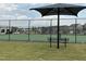 Community tennis courts featuring black fencing, shade structure, and bench seating at 1116 Sidney Creek Dr # 1116, Zebulon, NC 27597