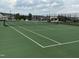 Community tennis courts featuring pristine green courts, black fencing, and neighborhood views at 1116 Sidney Creek Dr # 1116, Zebulon, NC 27597