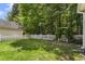 Spacious backyard featuring green lawn, mature trees, and a white picket fence at 121 Fort Jackson Rd, Morrisville, NC 27560