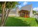 Well-maintained backyard featuring green lawn, privacy fence, and a screened porch at 121 Fort Jackson Rd, Morrisville, NC 27560
