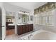 Bathroom featuring double sinks, soaking tub, tile floors, and natural light at 121 Fort Jackson Rd, Morrisville, NC 27560