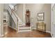 Elegant foyer featuring hardwood floors, a staircase, and classic decorative touches at 121 Fort Jackson Rd, Morrisville, NC 27560