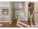 Spacious foyer features hardwood floors, a staircase, and a classic grandfather clock at 121 Fort Jackson Rd, Morrisville, NC 27560