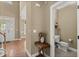 Inviting entryway featuring hardwood floors, a hall bathroom, and decorative accents at 121 Fort Jackson Rd, Morrisville, NC 27560