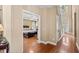 Hallway leading to a bedroom with hardwood floors and an open doorway at 121 Fort Jackson Rd, Morrisville, NC 27560