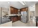 Kitchen featuring stainless steel appliances, dark cabinetry, and tile floors at 121 Fort Jackson Rd, Morrisville, NC 27560
