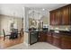 Open kitchen with dark cabinets and stainless steel dishwasher at 121 Fort Jackson Rd, Morrisville, NC 27560