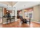 Eat-in kitchen with breakfast bar, dark cabinets, stainless appliances, and hardwood floors at 121 Fort Jackson Rd, Morrisville, NC 27560