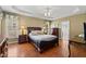 Spacious main bedroom featuring hardwood floors, a tray ceiling, and natural light at 121 Fort Jackson Rd, Morrisville, NC 27560