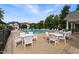 Community pool and sundeck furnished with white tables and lounge chairs at 121 Fort Jackson Rd, Morrisville, NC 27560