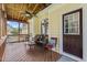 Charming screened-in porch featuring wood ceiling, fan, and comfortable seating area at 121 Fort Jackson Rd, Morrisville, NC 27560