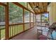Inviting screened porch with wood flooring, ceiling fan, and relaxing outdoor seating at 121 Fort Jackson Rd, Morrisville, NC 27560