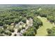 Aerial view of beautiful homes nestled within a lush, wooded neighborhood surrounding a golf course at 1211 E Pointe Dr, Durham, NC 27712