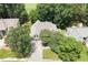 An aerial view shows the house nestled among lush trees and an expansive front lawn at 1211 E Pointe Dr, Durham, NC 27712